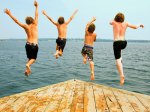 4 boys jumping off dock